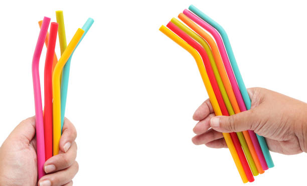 istock Coloured silicone drinking straw  in hands isolated on a white background with clipping path. eco friendly silicone straws for reusable. 1641291409