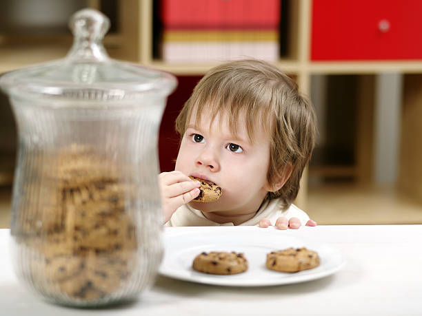 istock Little boy eating cookies 164129167