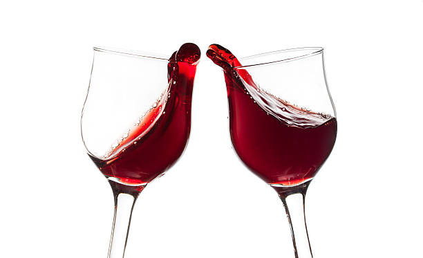 istock Cheers! Two red wine glasses, toast gesture, isolated on white 164132236