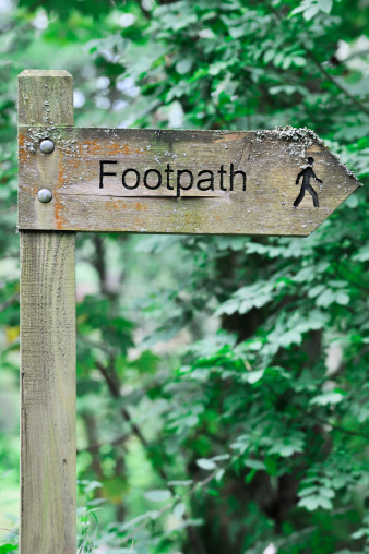 A signpost on the North Downs Way near Woldingham in Surrey, England, UK. The North Downs is part of the Surrey Hills Area of Outstanding Natural Beauty.