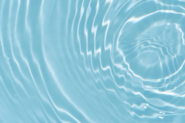 istock Blue water with ripples on the surface. Defocus blurred transparent blue colored clear calm water surface texture with splashes and bubbles. Water waves with shining pattern texture background. 1641438819