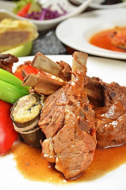 istock White plate of mutton chops with vegetables on dinner table 164144073
