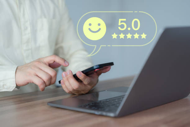 istock Male customer using a mobile phone or smartphone in give rating to service experience assessment on application. Online customer review satisfaction feedback survey and testimonial. 1641441578