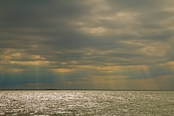 istock Sun rays through clouds on Oregon Inlet, North Carolina 164144246