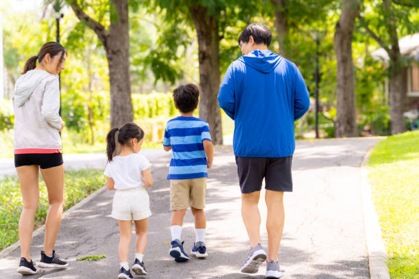 istock Asian family jogging exercise together at park. 1641460449