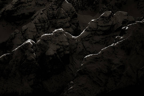 Dolomites, Italian Alps, Trentino-Alto Adige: silhouette of the the peaks of the mountains seen in low key. Monochrome.