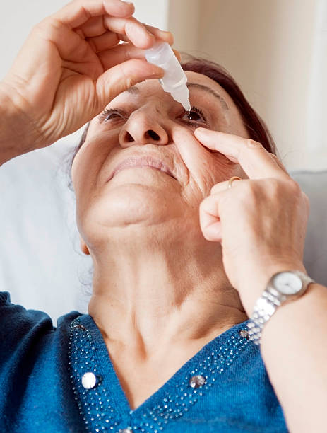 istock woman dripping eye drops 164147337