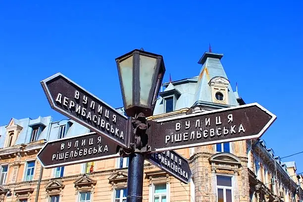 Old lantern with street signs to famous Deribasovskaya street in downtown Odessa, Ukraine