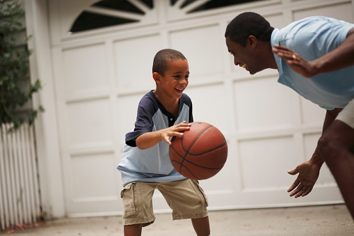 Father and son playing basketball