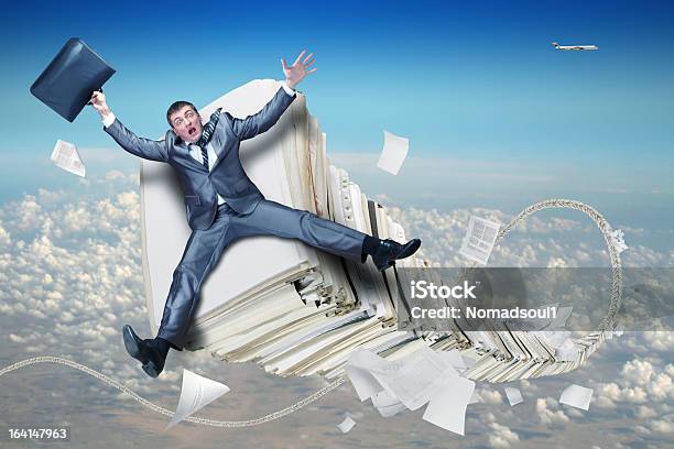 Businessman On Stack Of Paperwork Stock Photo - Download Image Now - File Folder, Flying, Achievement