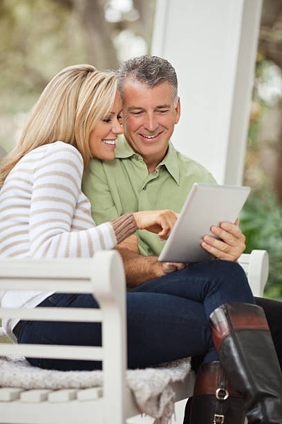 istock Happy couple in casuals surfing internet on digital tablet 164148101