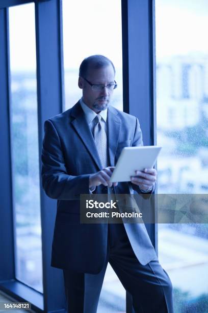 Businessman Using Digital Tablet At Office Stock Photo - Download Image Now - 50-54 Years, 50-59 Years, Adult