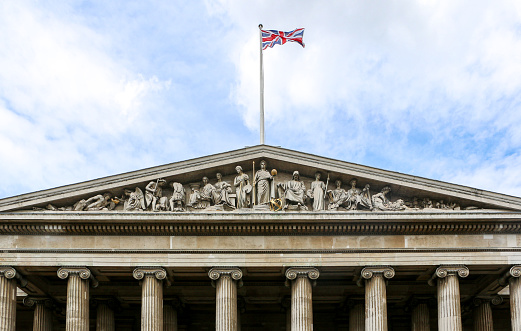 London, England, United Kingdom - View of the the British Union Jack Flag flying above The British Museum building at the main entrance.