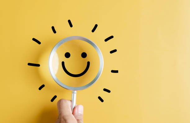 istock Magnifier focus to smile face emoticon with light bulb smart idea, creativity and solution concept. 1641515626