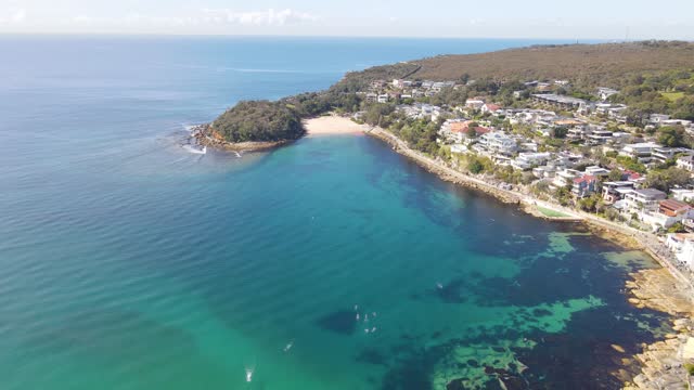 Aerial drone pullback reverse view of Shelly Beach at Manly on the Northern Beaches of Sydney, NSW