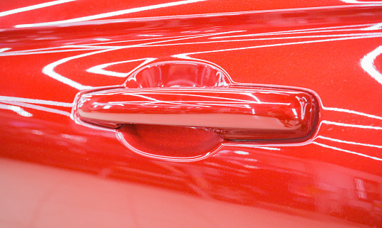 Red car door handle close-up.