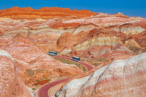 Photo of buses in the Danxia Landform of Zhangye, Gansu, China. Copy space for text