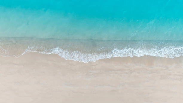 istock Beach Wave water in the Tropical summer beach with  sandy beach background 1641547089