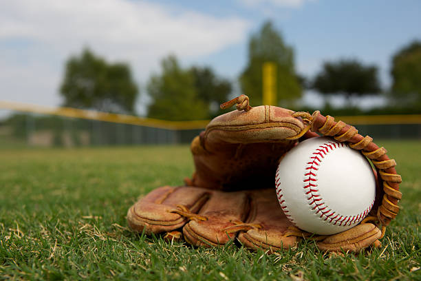 Baseball in a Glove New Baseball in a Glove in the Outfield baseball ball photos stock pictures, royalty-free photos & images
