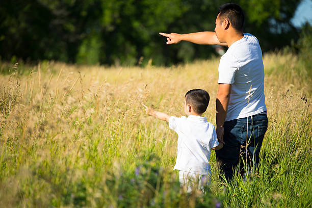 istock Asian father and son in grass field 164158746