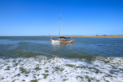 Sailing boat in front of East Frisian island Baltrum, Germany