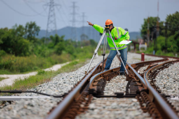istock Engineer use theodolite equipment surveying construction worker on Railway site. 1641611314