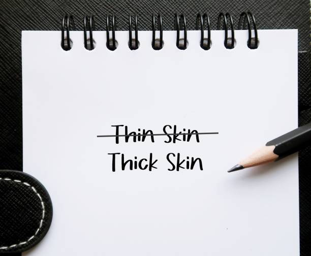 istock Pencil on notebook written THIN SKIN and THICK SKIN, self reminder to develop thicker skin, stop being too sensitive, refuse to get overly responsive to negative comments of others 1641620380