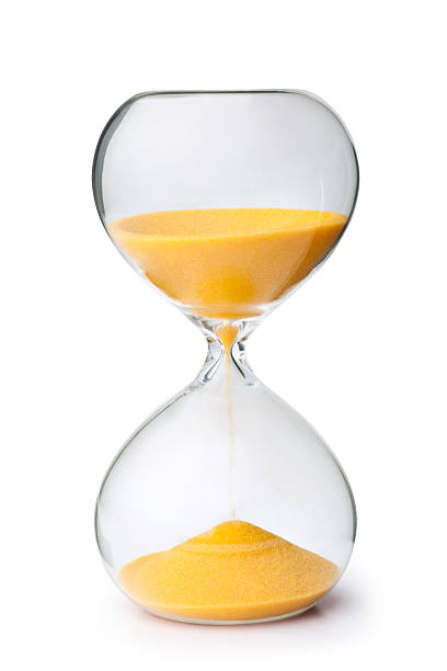 Close-up of yellow sand inside an hourglass
