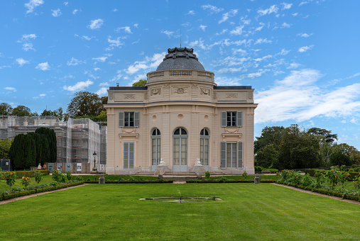 Boulogne-Billancourt, France - August 13 2023: Bagatelle castle in the Bagatelle park. This small castle was built in 1777 in Neoclassical-style. Located in Boulogne-Billancourt near Paris, France