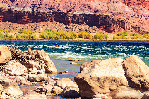 Stormy stream of water on stone rifts. Lees Ferry in the USA - the famous ferry crossing the Colorado River and the Grand Canyon in Arizona. Lovely warm sunny day.