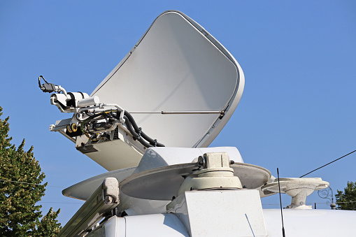 Satellite dish antenna on the top of a television car