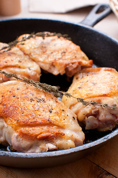 istock Fried chicken thighs in cast iron pan 164166602
