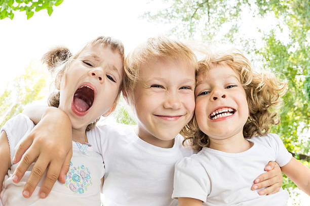 two laughing kids outdoors