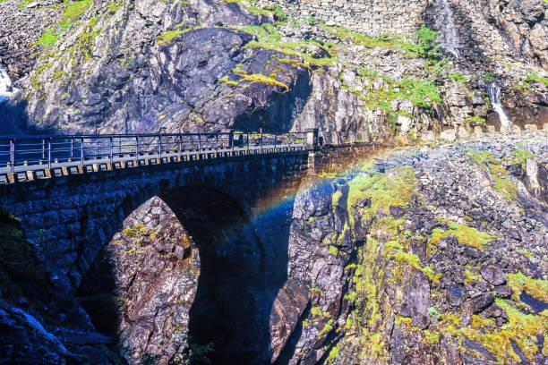 Old stone bridge with a rainbow in the arch