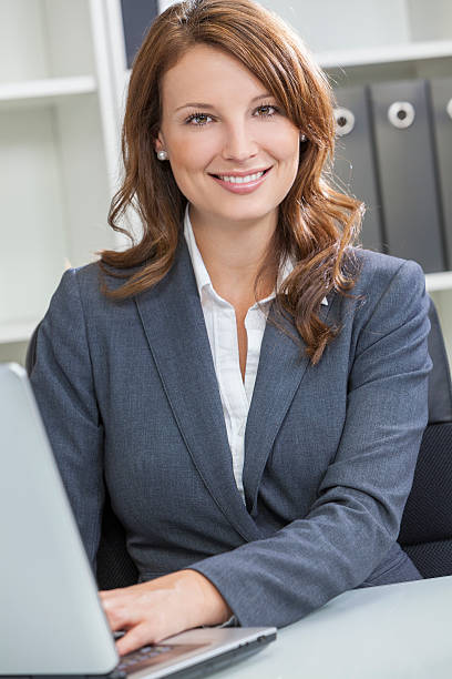 istock Woman or Businesswoman Using Laptop Computer in Office 164168384