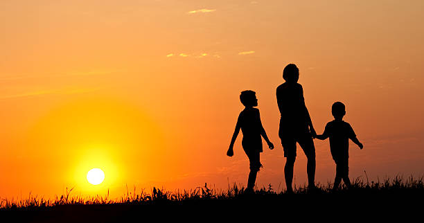 istock Mother Walking With Children at Sunset 164170280