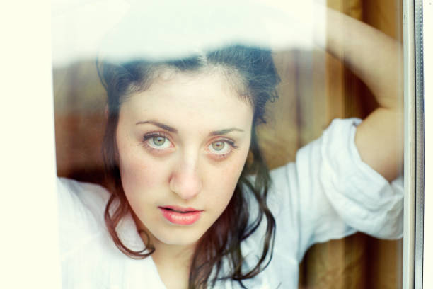 istock Cute girl looking throught window 164170332