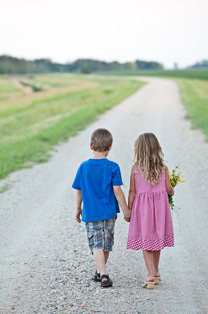 istock Cute Couple Walking Down Gravel Road 164170399