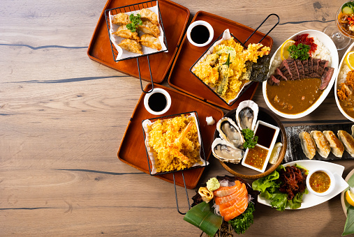 Top view many traditional gourmet japanese food dishes on wood table. Japanese food isolated on wood background