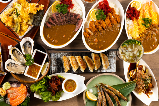 Top view many traditional gourmet japanese food dishes on wood table. Japanese food isolated on wood background