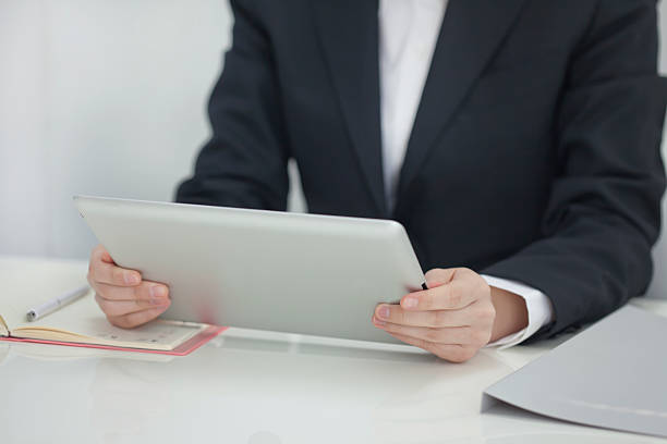 istock The businesswoman who operates a tablet PC 164170667