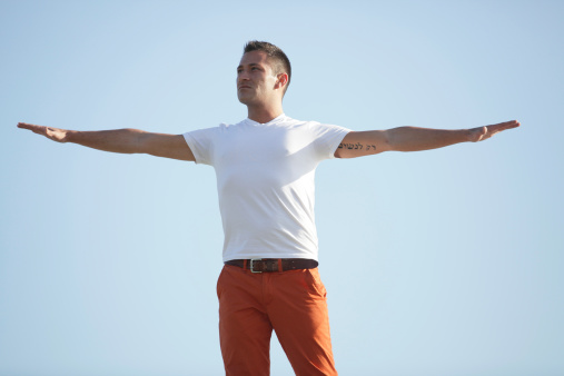 Image of a handsome young man with arms outstretched
