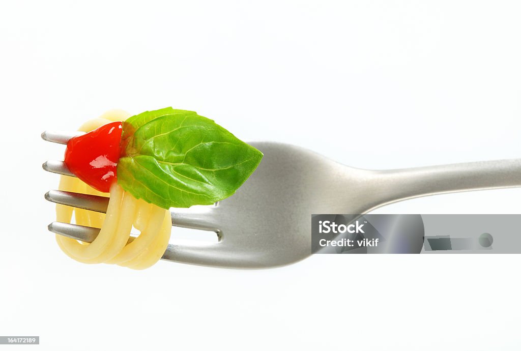 Spaghetti with ketchup on fork Spaghetti with ketchup twirled on fork Basil Stock Photo