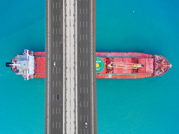 istock Aerial view of a cargo ship passing under bridge. 1641755319