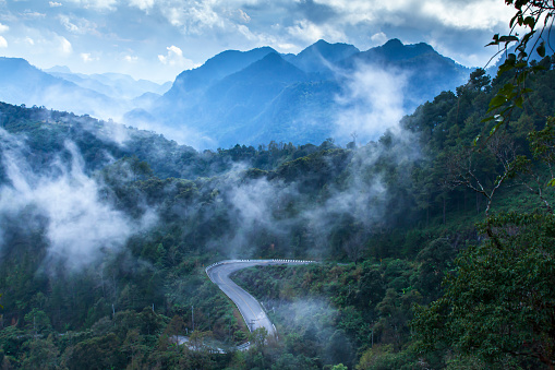 The scenery of the mountain road in the morning fog, the curved road through the mountain range near the Thailand-Myanmar border.