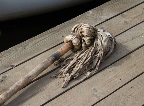 istock a mop for cleaning on the pier lies on a wooden deck 1641773473