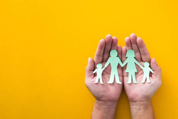istock Top view hands with paper cut family 1641789747