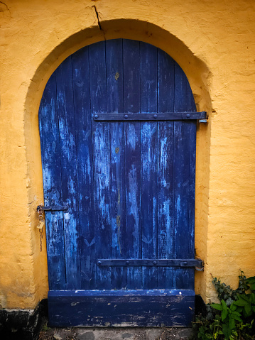 Beautiful entrance door details in an ancient well preserved town - colorful welcome