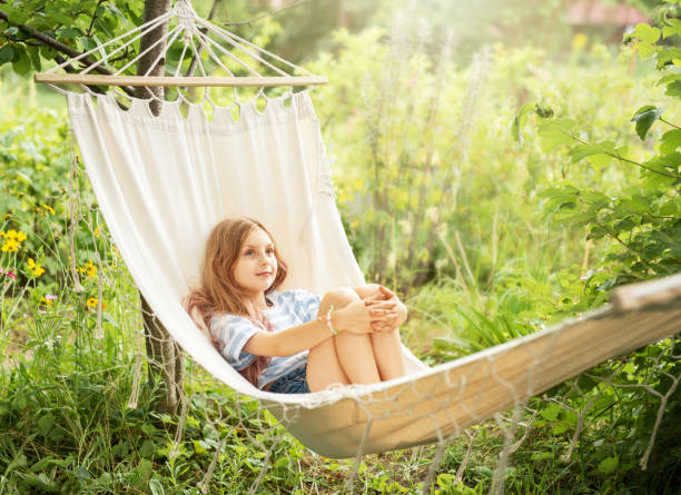 istock A little girl rests in a hammock and eats cherries in the summer. 1641846065