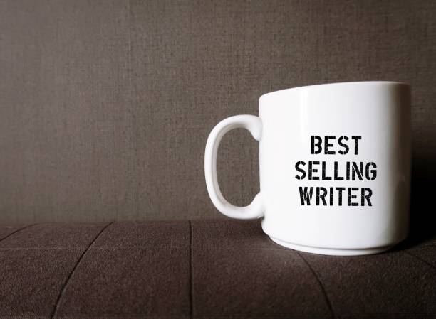 istock White coffee cup mug on gray copy space background with printed text on the side BESTSELLING WRITER, refers to a successful author or passionate , goat setting writer who aim to be one 1641846094